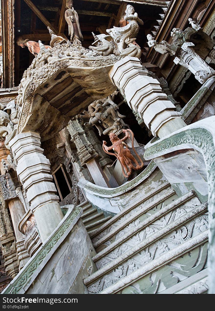 In Thailand in the city of Pattaya the sanctuary of truth is a wooden construction high of 105 meter covered with wooden carved sculpture; view of the sculpted roof. In Thailand in the city of Pattaya the sanctuary of truth is a wooden construction high of 105 meter covered with wooden carved sculpture; view of the sculpted roof