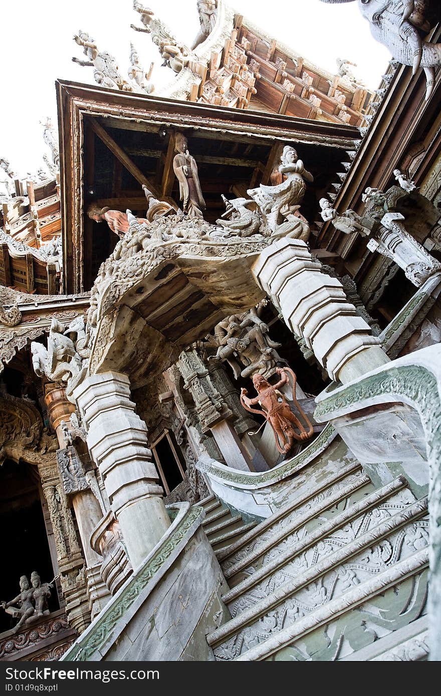 In Thailand in the city of Pattaya the sanctuary of truth is a wooden construction high of 105 meter covered with wooden carved sculpture; view of the sculpted roof. In Thailand in the city of Pattaya the sanctuary of truth is a wooden construction high of 105 meter covered with wooden carved sculpture; view of the sculpted roof