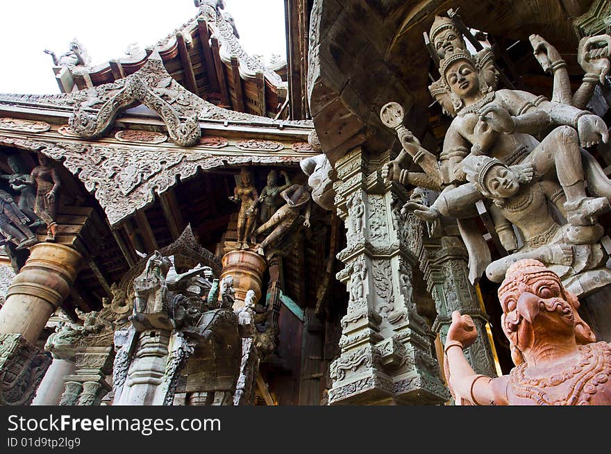 In Thailand in the city of Pattaya the sanctuary of truth is a wooden construction high of 105 meter covered with wooden carved sculpture; view of the sculpted roof. In Thailand in the city of Pattaya the sanctuary of truth is a wooden construction high of 105 meter covered with wooden carved sculpture; view of the sculpted roof