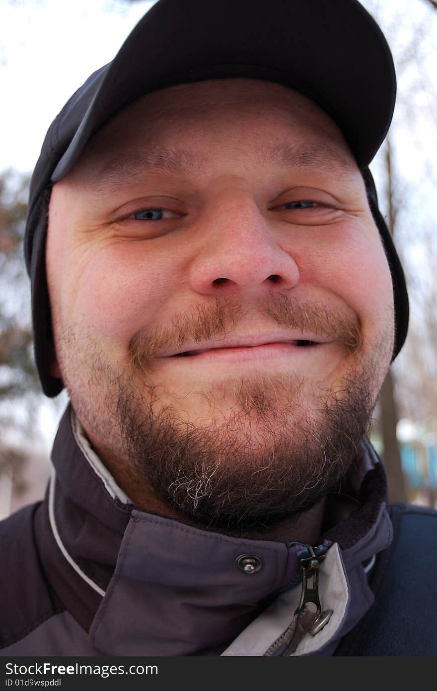 Portrait of happy young man. Outdoors.