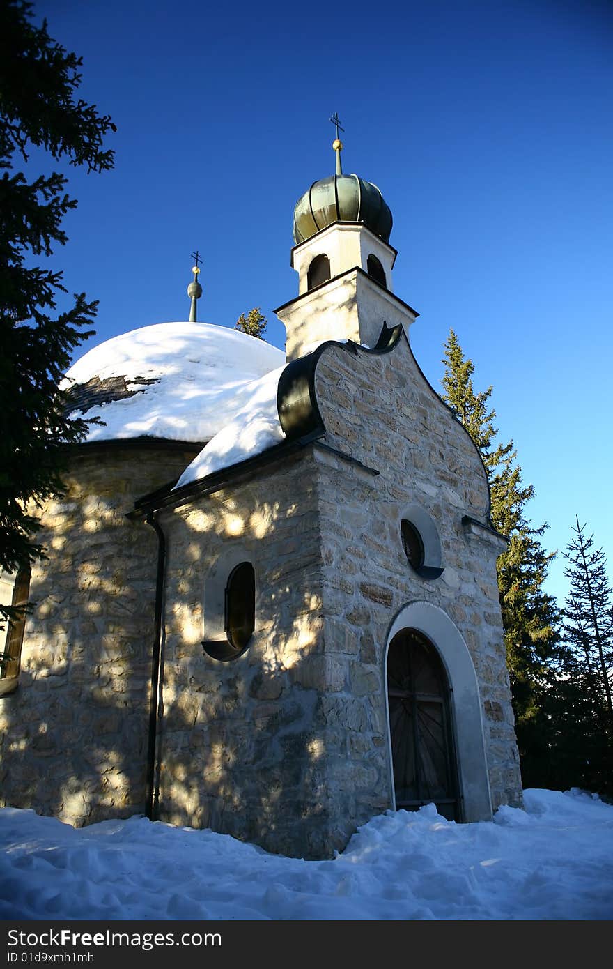 Chappel in the snow and mountain