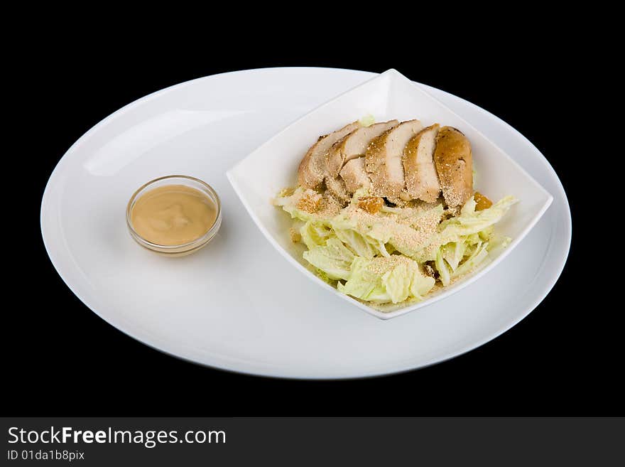 Meat with vegetables over black background