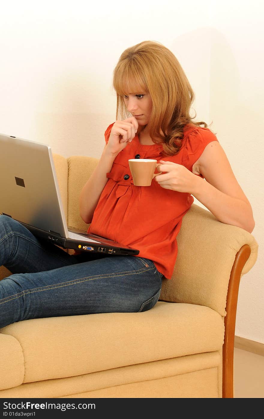 Young woman at home, working on her laptop.