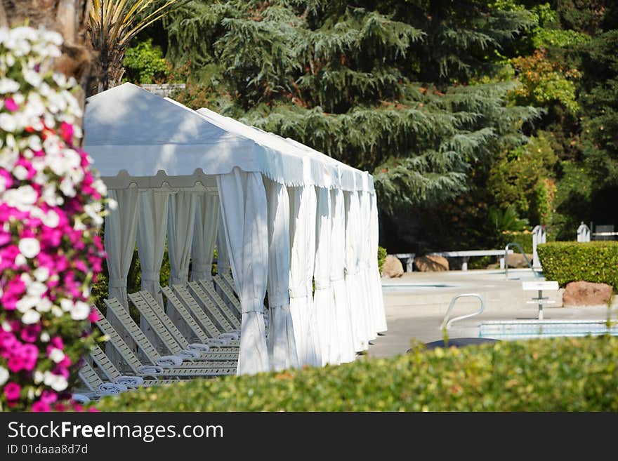 White tents at a tropical resort pool side