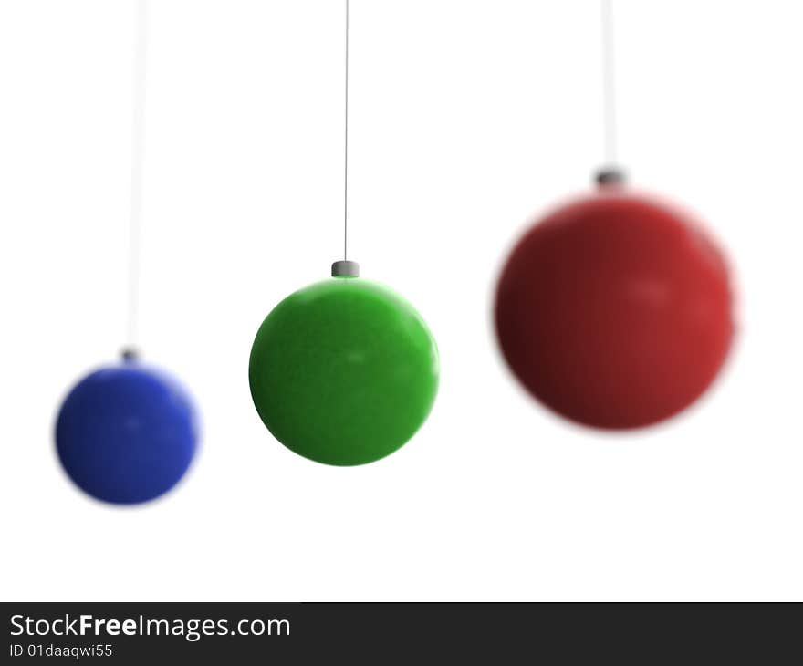 Three Christmas toys of blue, green and red color with middle one in focus hanging on white background