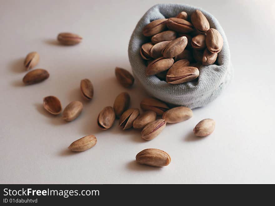 Pistachio nuts falling out of  small bag