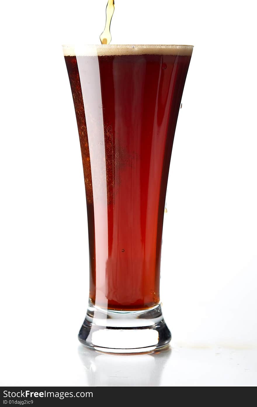 Glass with beer on the white background