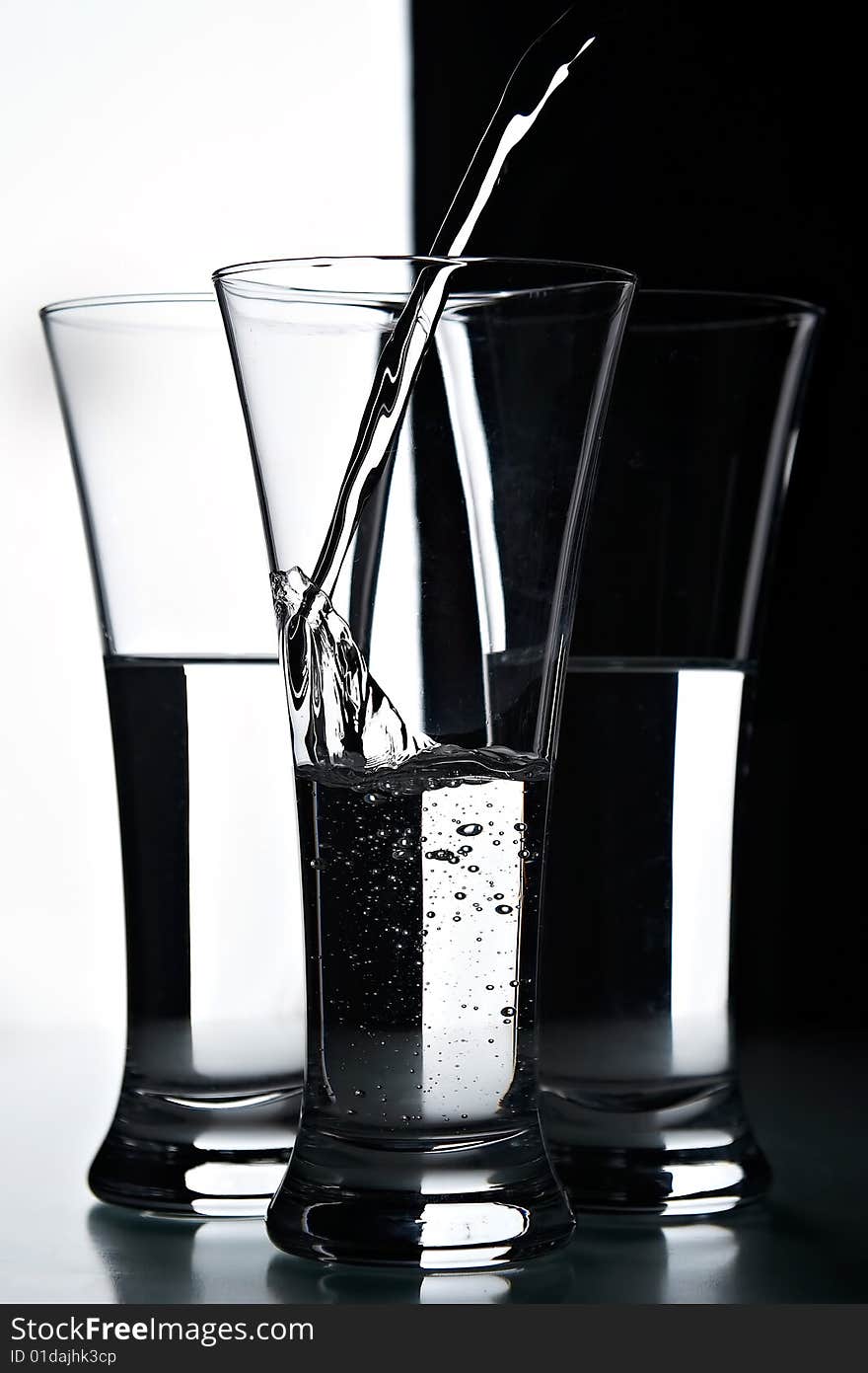 Glasses with water on the white and black background