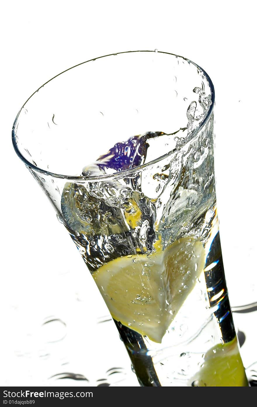 Glass with water and lime on the white background