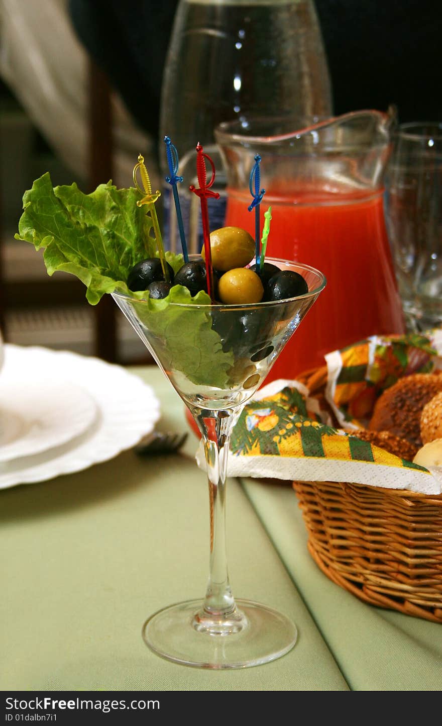 Olives in a glass on a celebratory table