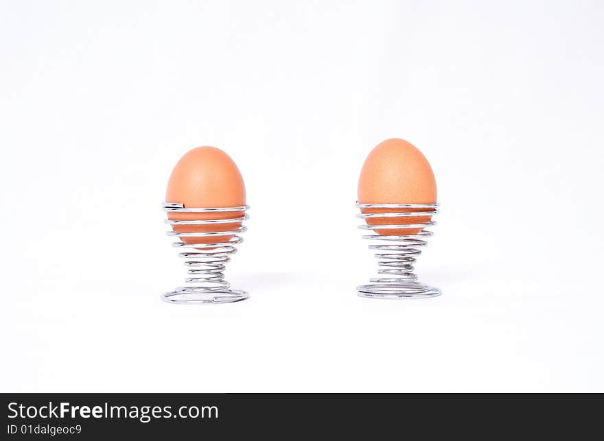 Two boiled eggs in modern spiral eggcups.