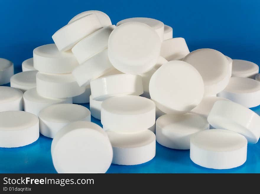 Closeup of a pile of white pills