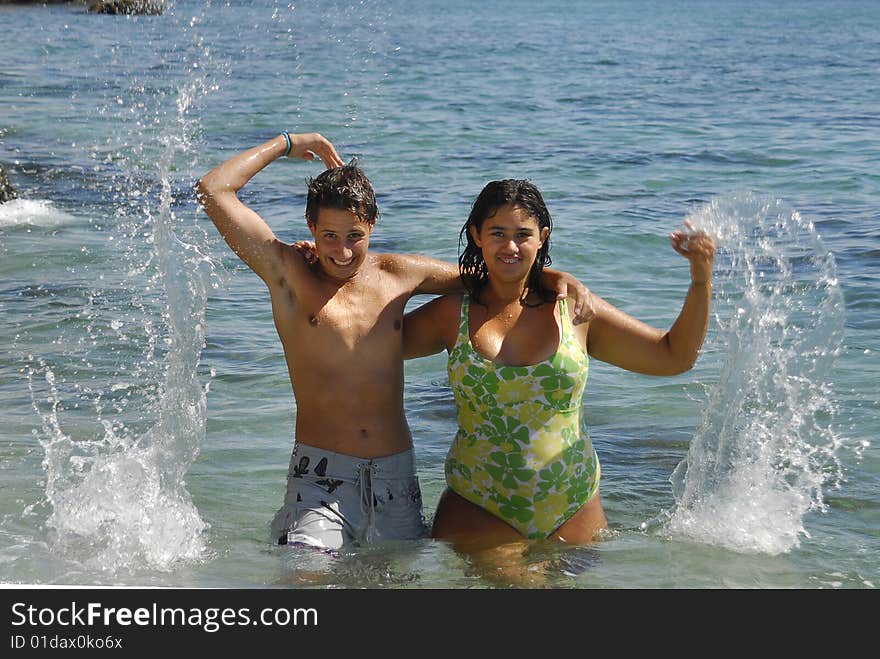 Young couple playing in the sea. Young couple playing in the sea