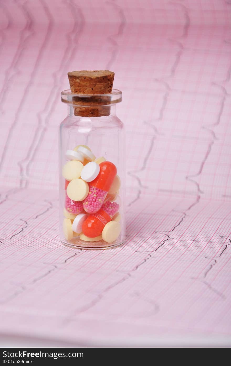 Pill and bottle on electrocardiogram