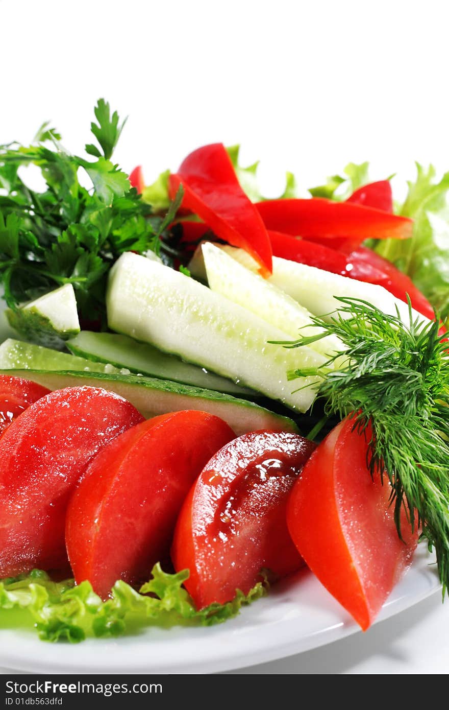 Fresh Vegetables Plate with Parsley, Salad Leaves and Dill. Isolated on White Background