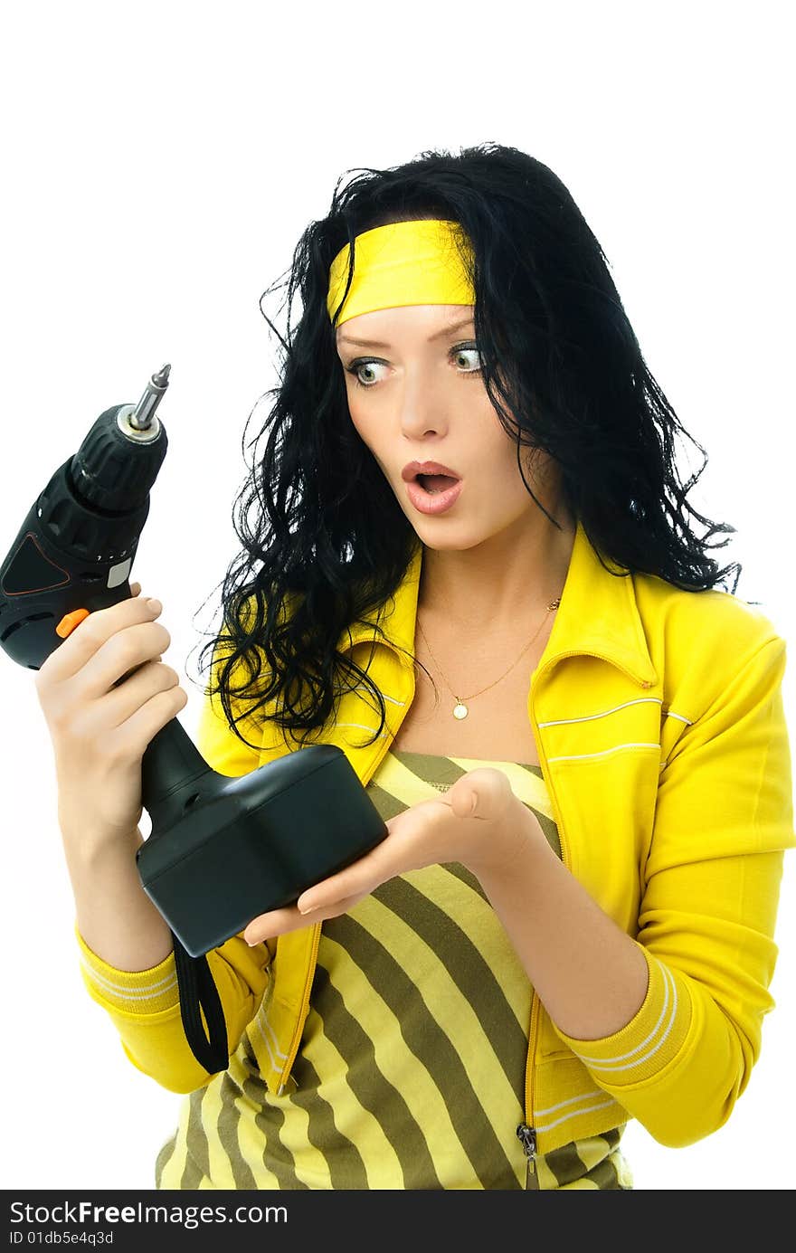 Beautiful young surprised woman holding a drill isolated against white background. Beautiful young surprised woman holding a drill isolated against white background