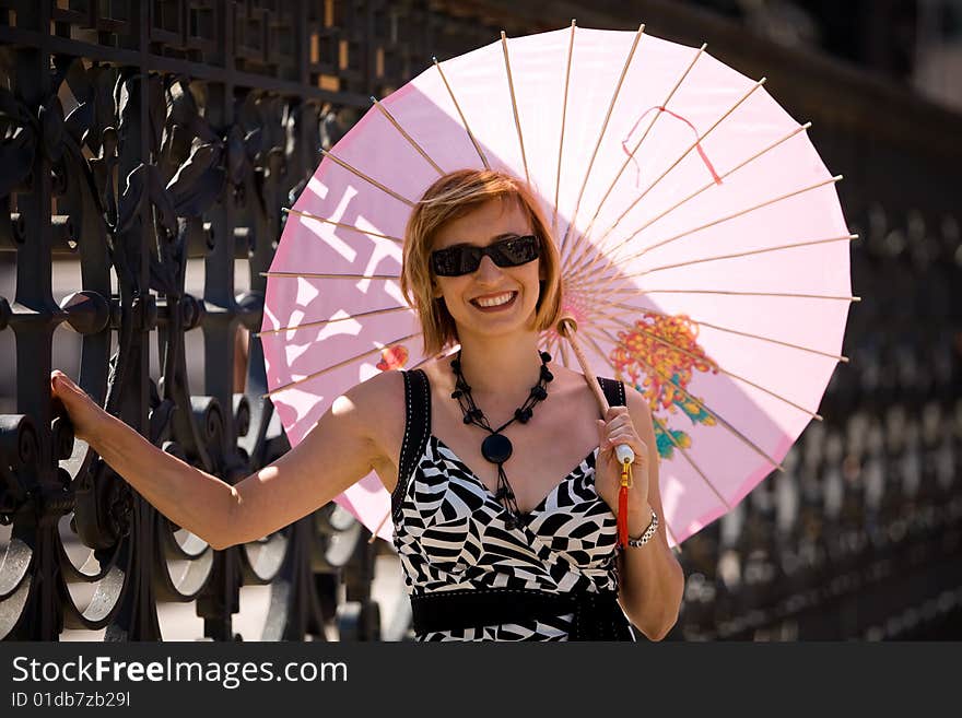 Lovely woman with pink sunshade in Rome town