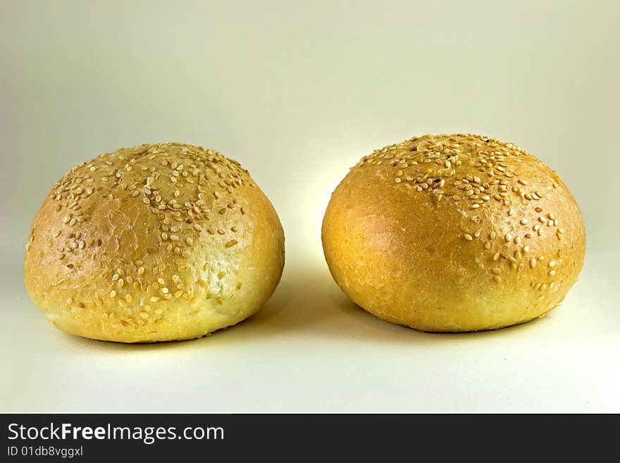 Two sesame buns on white background