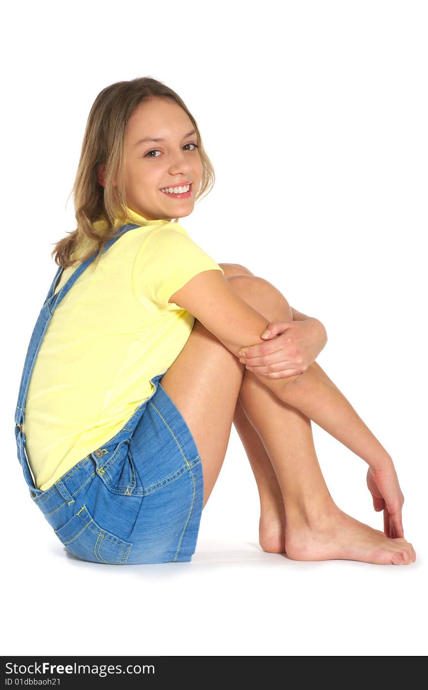 Laughing teenage girl on white floor