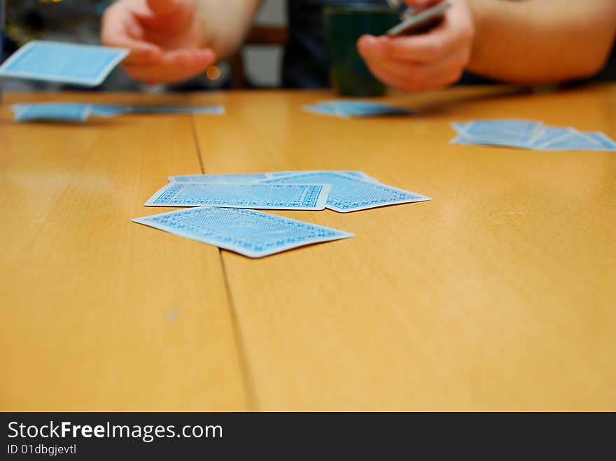 Hands dealing cards on the table. Hands dealing cards on the table