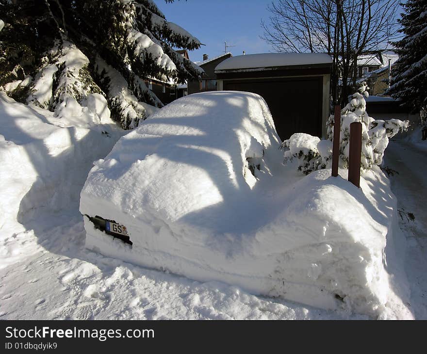 My white car.
Car covered with snow in the winter blizzard