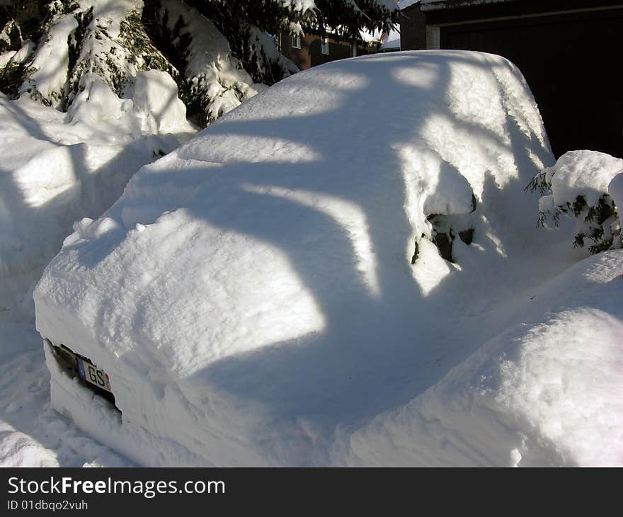 Cold car.
 Car covered with snow in the winter blizzard