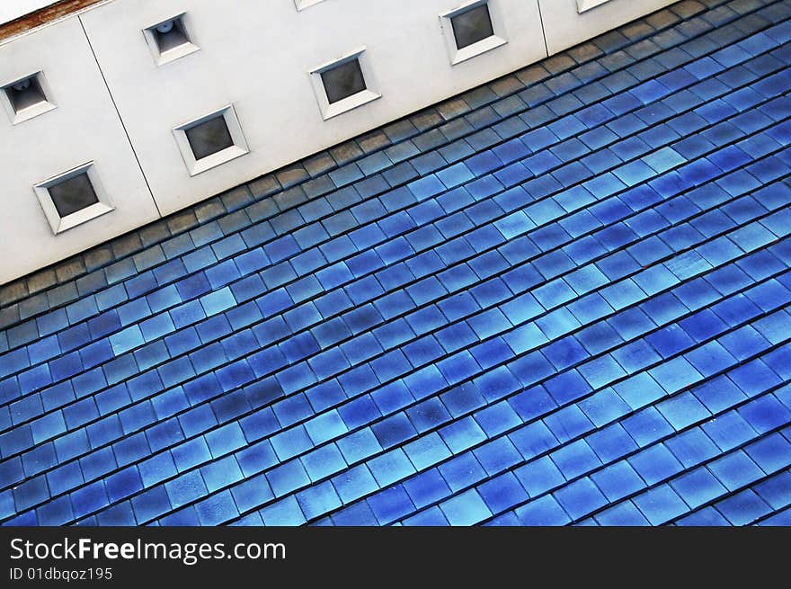 Large portion of a roof with blue shingles. Large portion of a roof with blue shingles