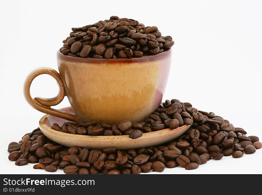 This ' a a stack of coffee beans with cup and plate. This ' a a stack of coffee beans with cup and plate