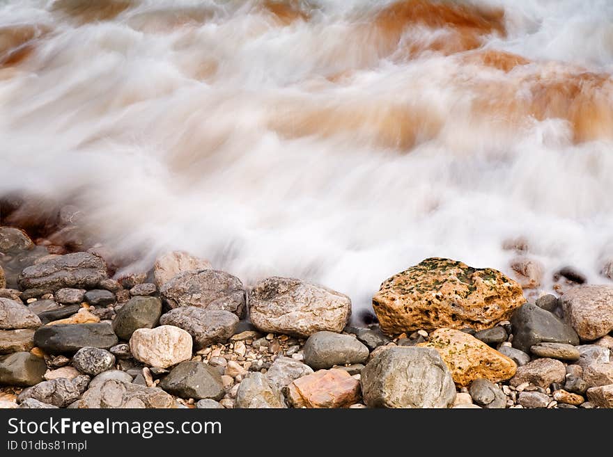 A sea rocky shore with water motion. A sea rocky shore with water motion