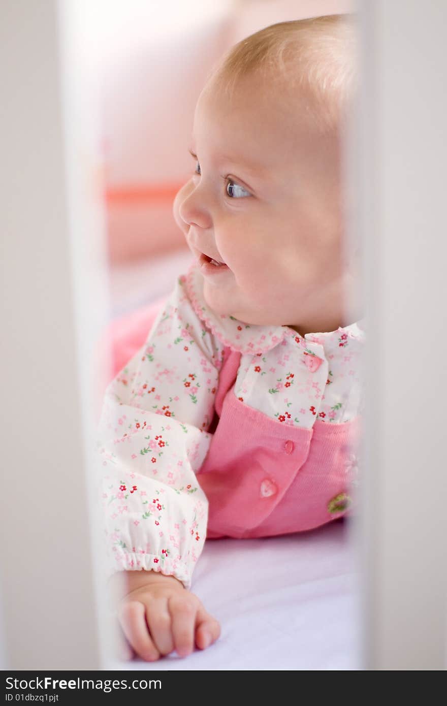 Little baby in her bed - look through the fence