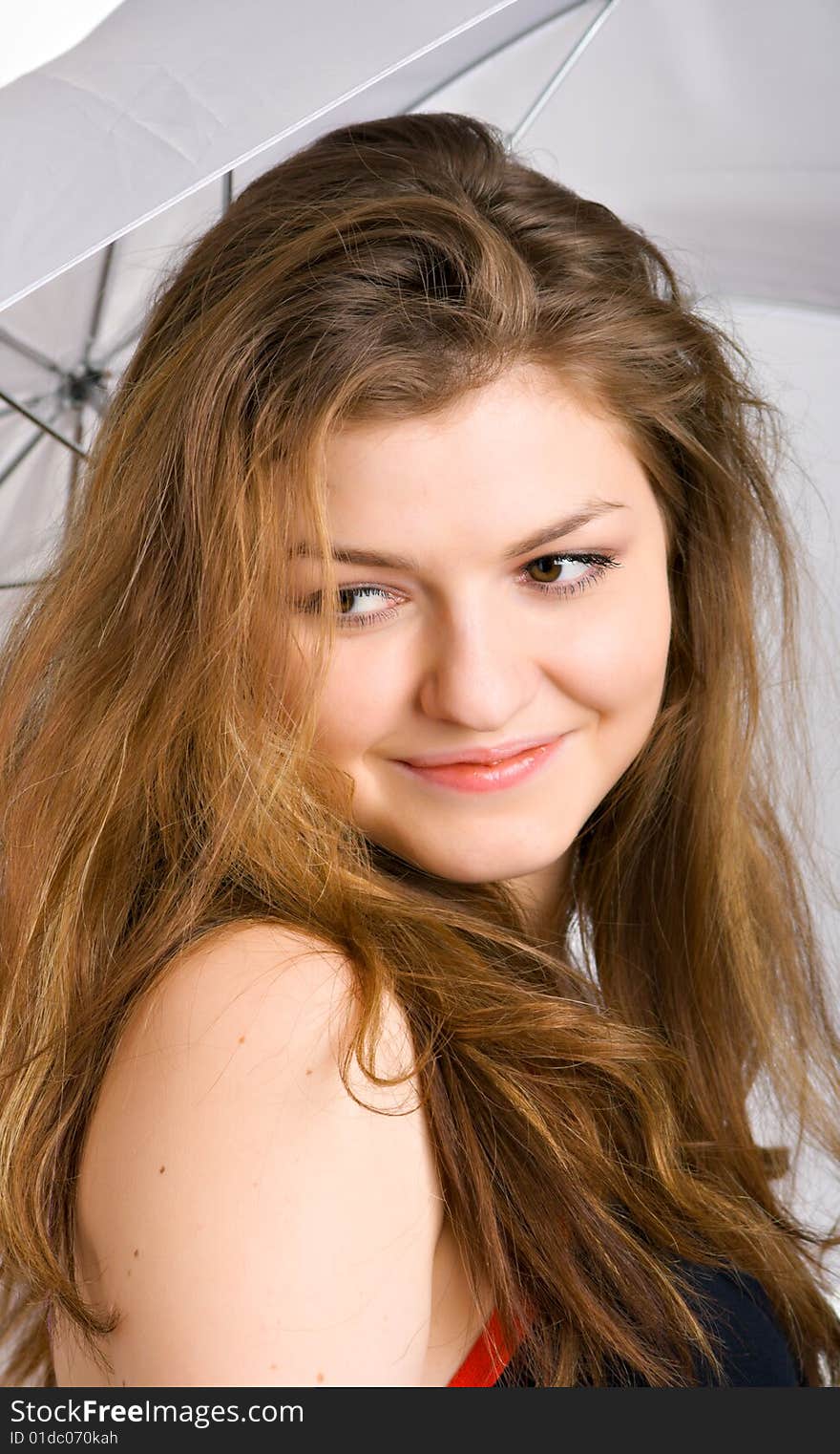 Smiling brunette under a white umbrella