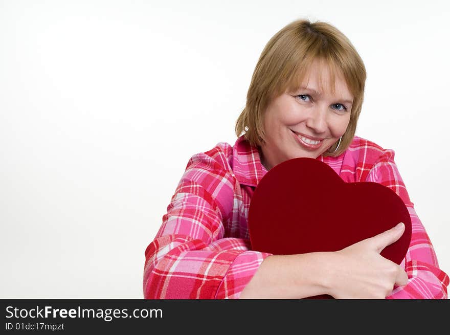 An attractive woman hugs the box of valentines day chocolates she just received as a gift. An attractive woman hugs the box of valentines day chocolates she just received as a gift.