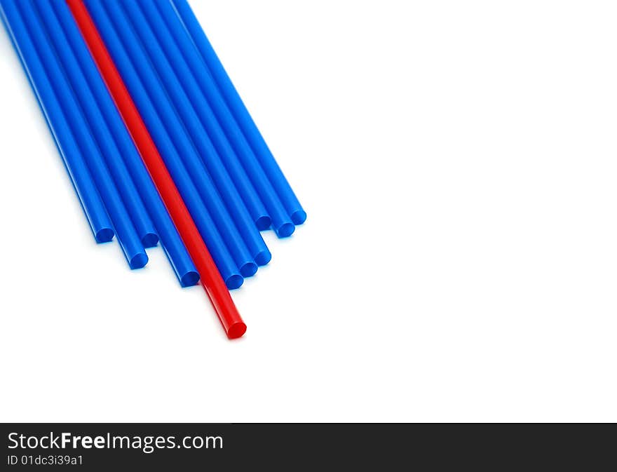 Single red straw between many blue straws. Single red straw between many blue straws