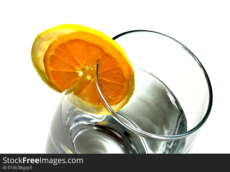 Fresh water with glass, lemon and orange decorated whit a circle. Isolated on white background. Fresh water with glass, lemon and orange decorated whit a circle. Isolated on white background.