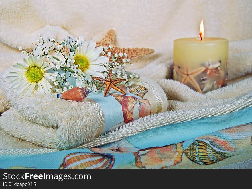 Stafish, daisies and candle on fluffy towels. Stafish, daisies and candle on fluffy towels.