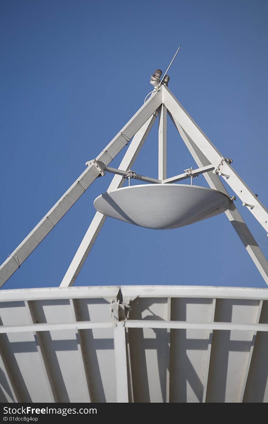 A large satellite dish by parabolic antenna on blue sky