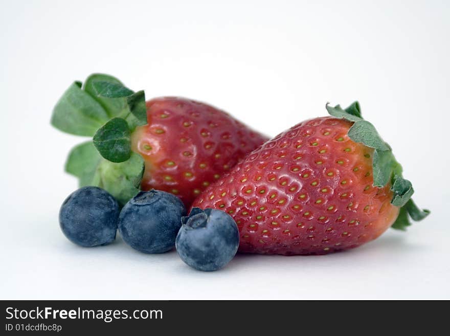 Two juicy strawberries, and three plump blueberries. Two juicy strawberries, and three plump blueberries