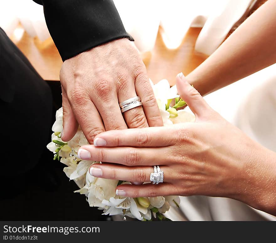 Couple shows wedding rings.