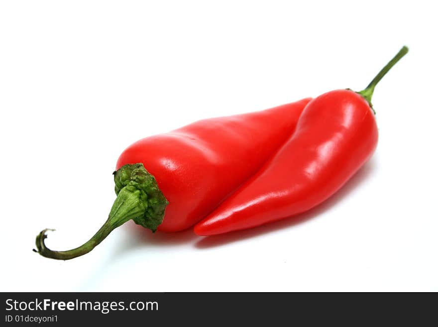 A red jalapeno pepper isolated on a white background. A red jalapeno pepper isolated on a white background.