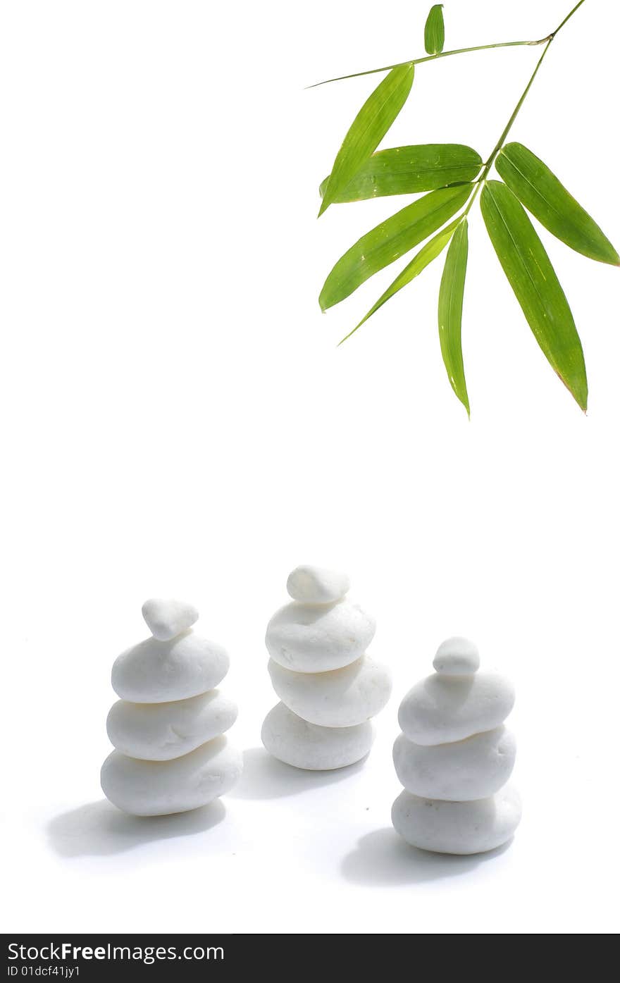 Bamboo leafs and zen stones isolated on white