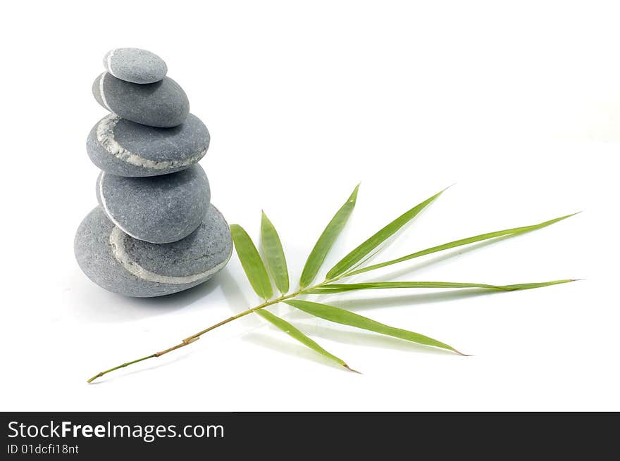 Bamboo leafs and zen stones isolated on white