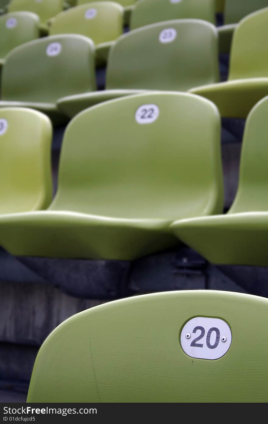 Lime-green stadium seats, number twenty. Lime-green stadium seats, number twenty