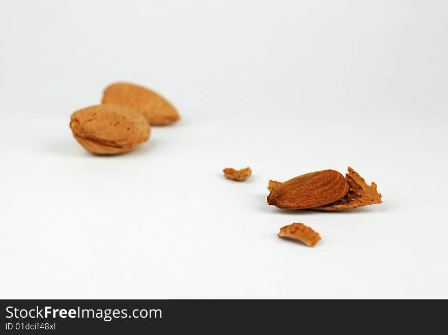 Three almond nuts on a white background. Three almond nuts on a white background