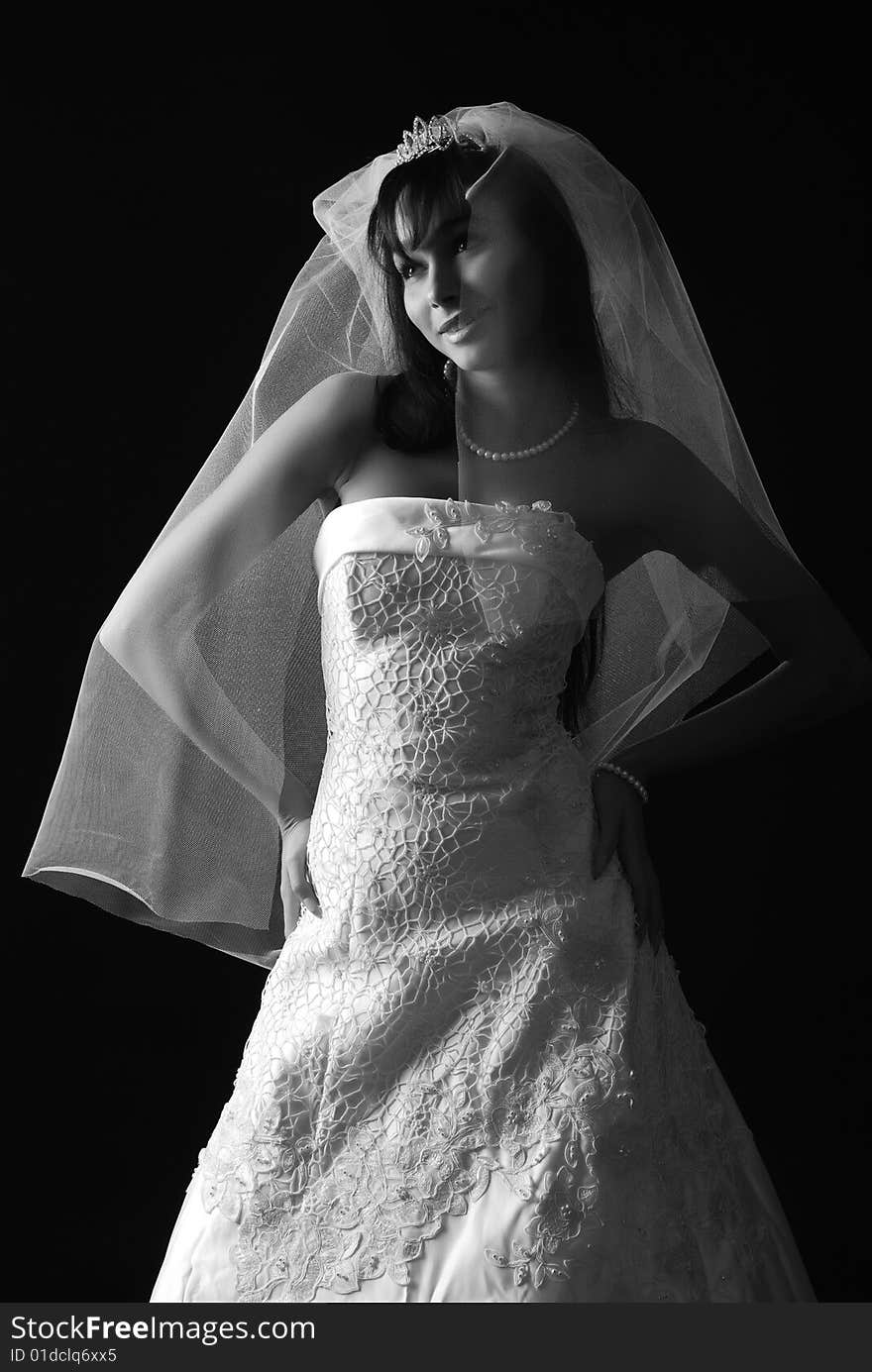 Young bride with dark hair on a black background