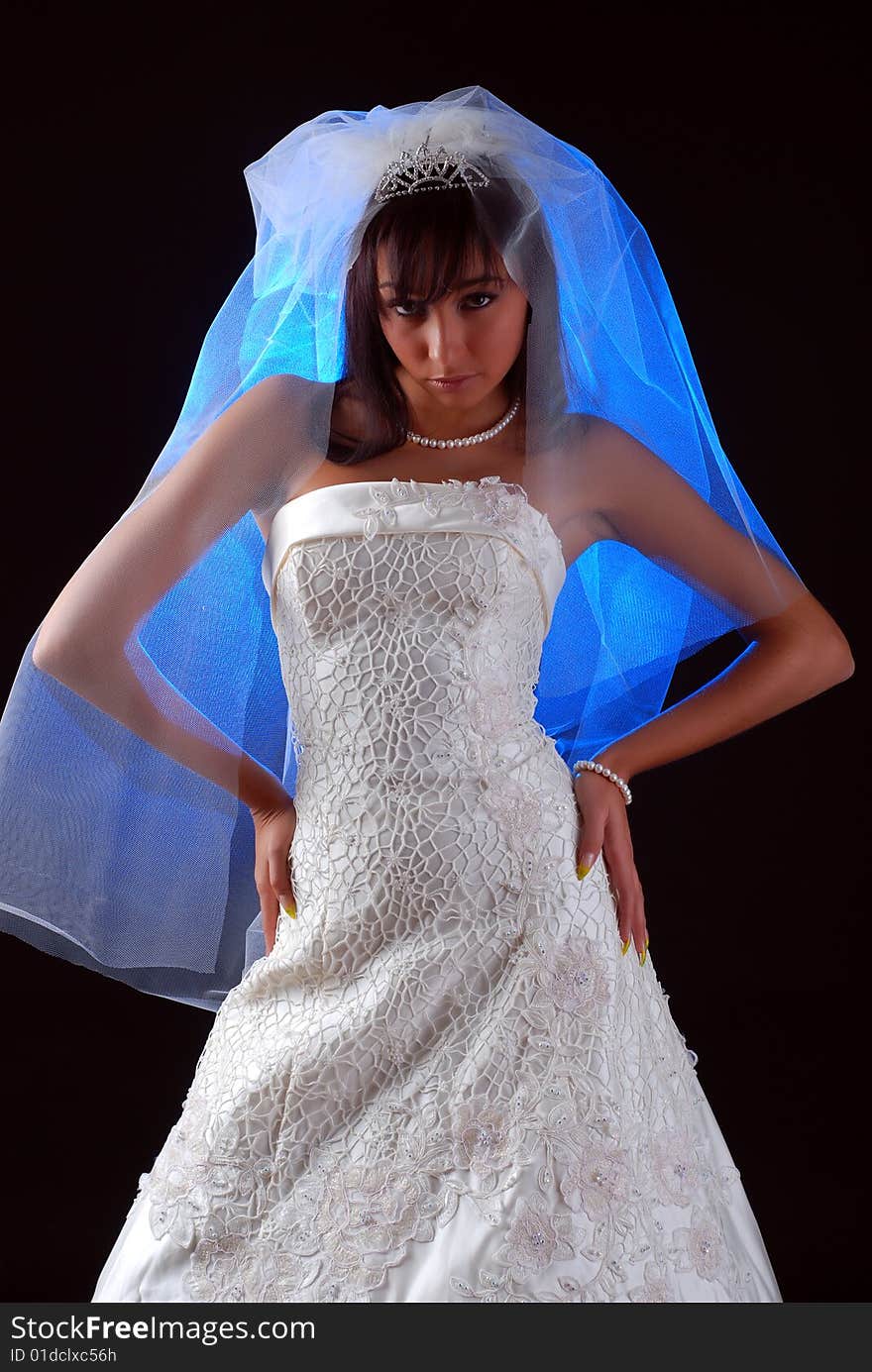 Young bride with dark hair on a black background