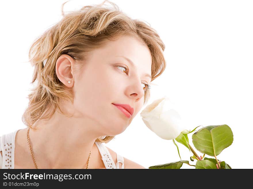 Portrait of attractive blond girl smelling rose