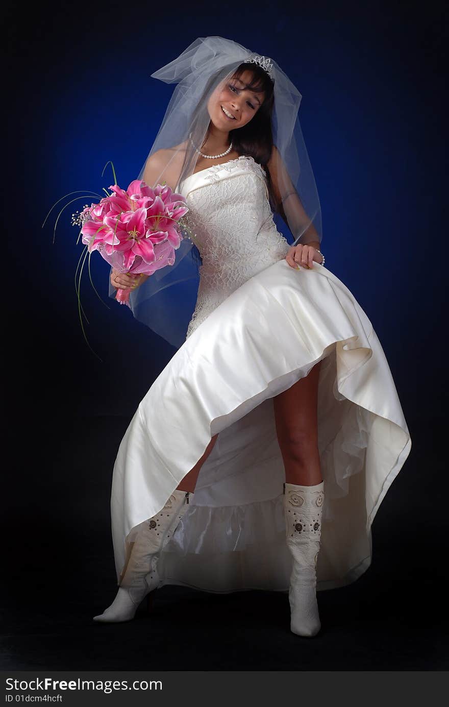 Young bride with bouquet of lilys show her legs