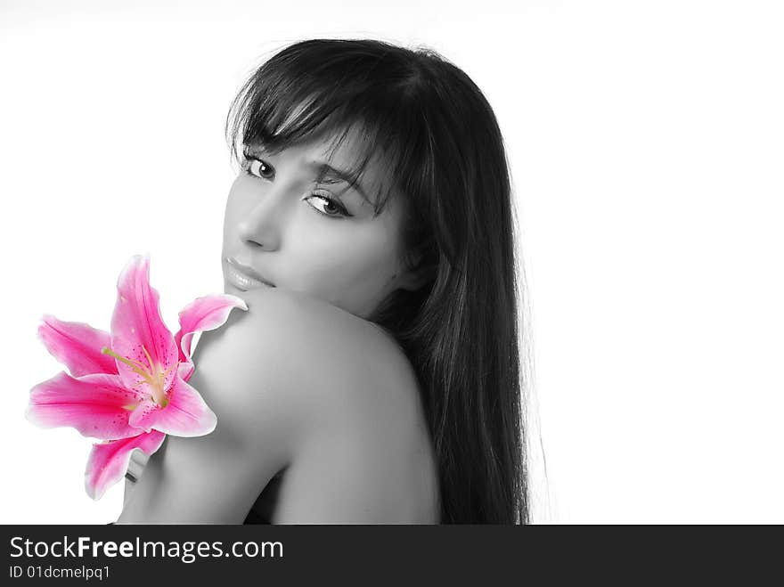 Beautiful young woman with lily on her shoulders