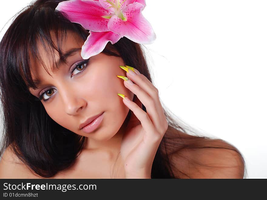 Beautiful young woman with lily in her hair