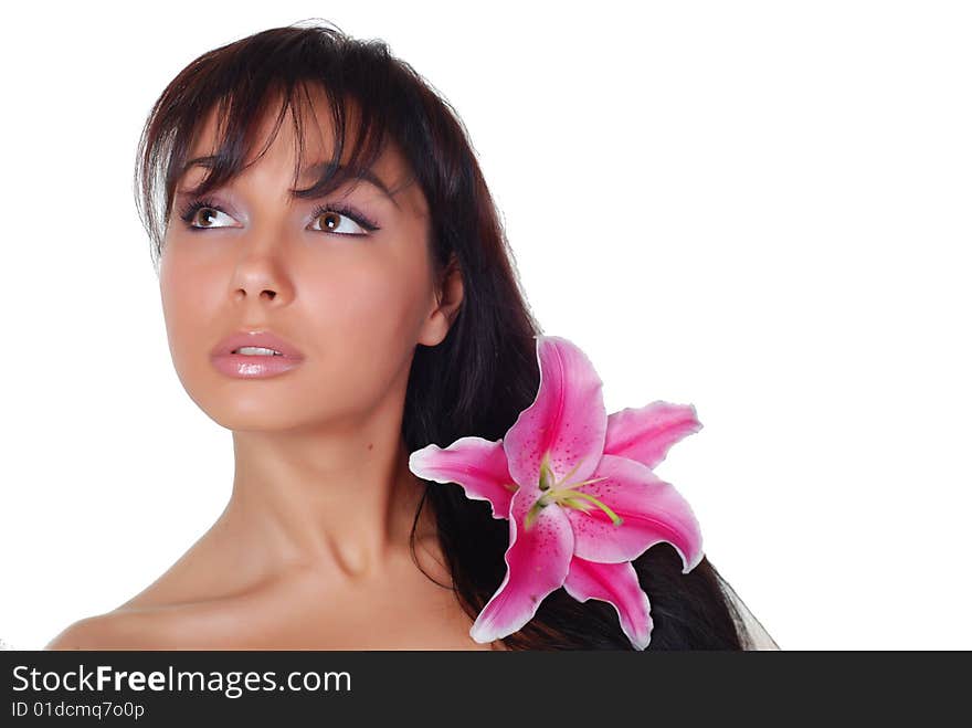 Beautiful young woman with lily in her hair